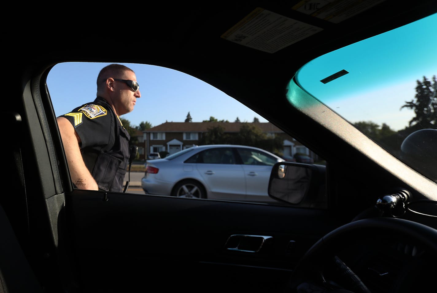 Hopkins police officer Sgt. Mike Glassberg was out patrolling Hopkins roads looking for violators on the first day of the new hands free law Thursday, Aug. 1, 2019, in Hopkins, MN. Here, Sgt Glassberg prepared to issue a ticket to a driver that had been holding a cell phone while using it for the violation near Hopkins Crossroad and Shady Oak Rd..