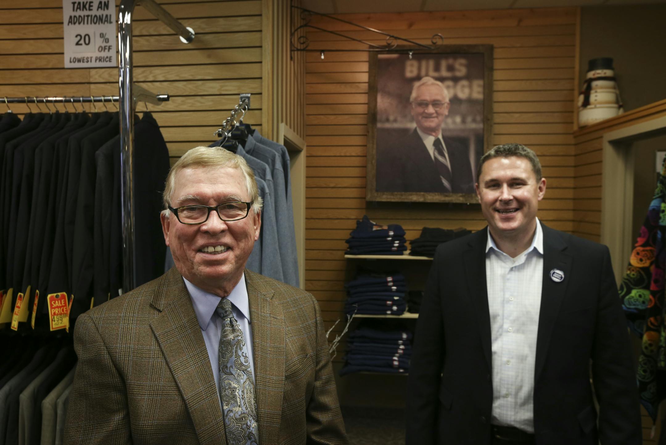Bill Wermerskirchen and his son Billy Wermerskirchen, right, under a portrait of Bill's father and Billy's grandfather Bill Wermerskirchen at Bill's Toggery in Shakopee, Minn., on Tuesday, November 25, 2014. Bill Wermerskirchen, left, will retire this year and his son continue the family business. ] RENEE JONES SCHNEIDER • reneejones@startribune.com