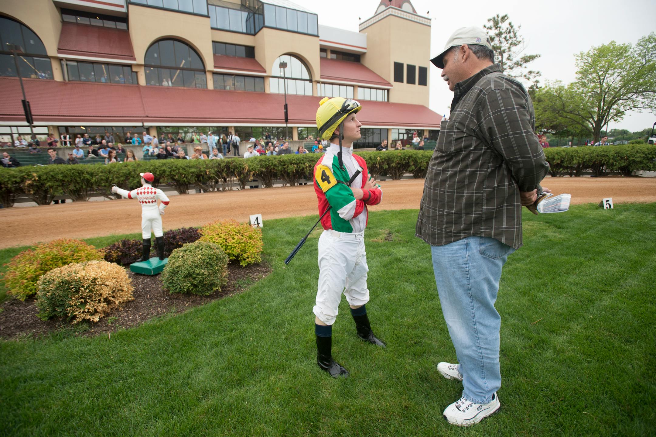 Ron Venturini, right, one of the owners of Sheza Ruler, talked with jockey Justin Shepherd before the third race Friday night at Canterbury Park.