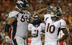 Denver Broncos wide receiver Emmanuel Sanders (10) salutes with offensive tackle Ryan Harris (68) by his side after he scored a touchdown against the 