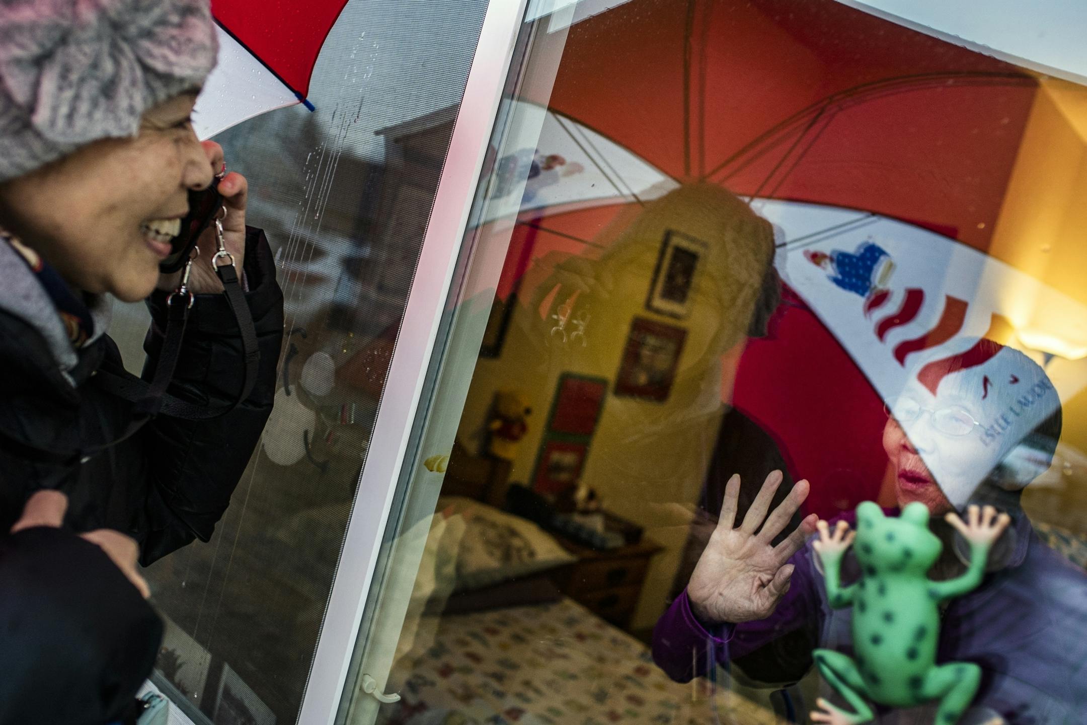 Danielle Jin, 57, visited her mother, Juan Zhu, 91, at an assisted-living facility in Vadnais Heights. Jin must talk to her mother at the window because the facility will not allow family members to visit during the coronavirus outbreak. Her mother has Alzheimer's but still recognizes her daughter. Jin brings her mother some Chinese food for dinner daily.