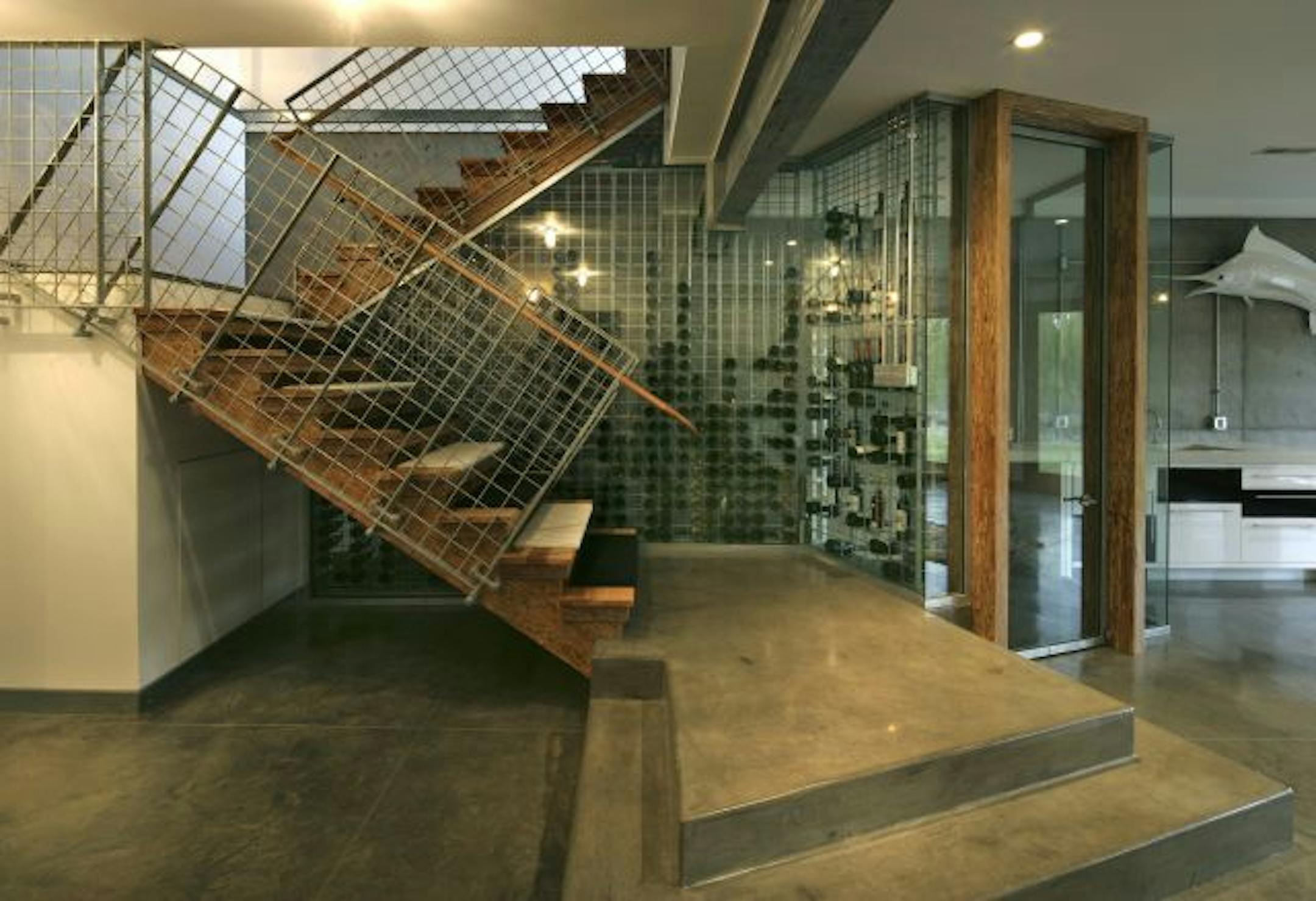 The wine cellar and staircase are made of galvanized metal; Smith, who works in the industrial warehouse business, chose many industrial materials for his home.