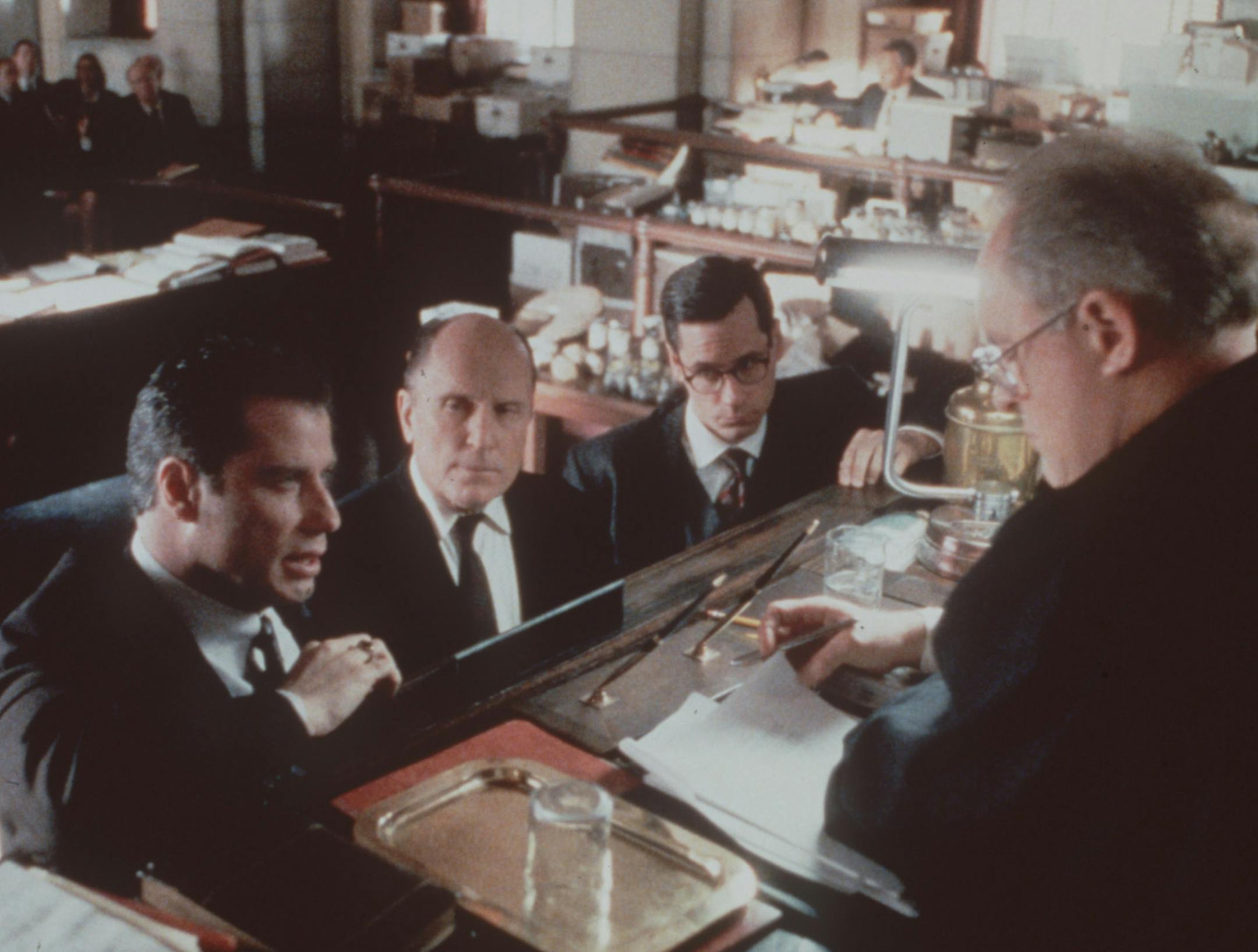 John Travolta (at left) gets help from a strong supporting cast which includes Robert Duvall (second from left), Bill Crowley, and John Lithgow (at right) in the movie "A Civil Action." Handout photo David James, courtesy of Touchstone Pictures. ORG XMIT: MIN2013080208554319