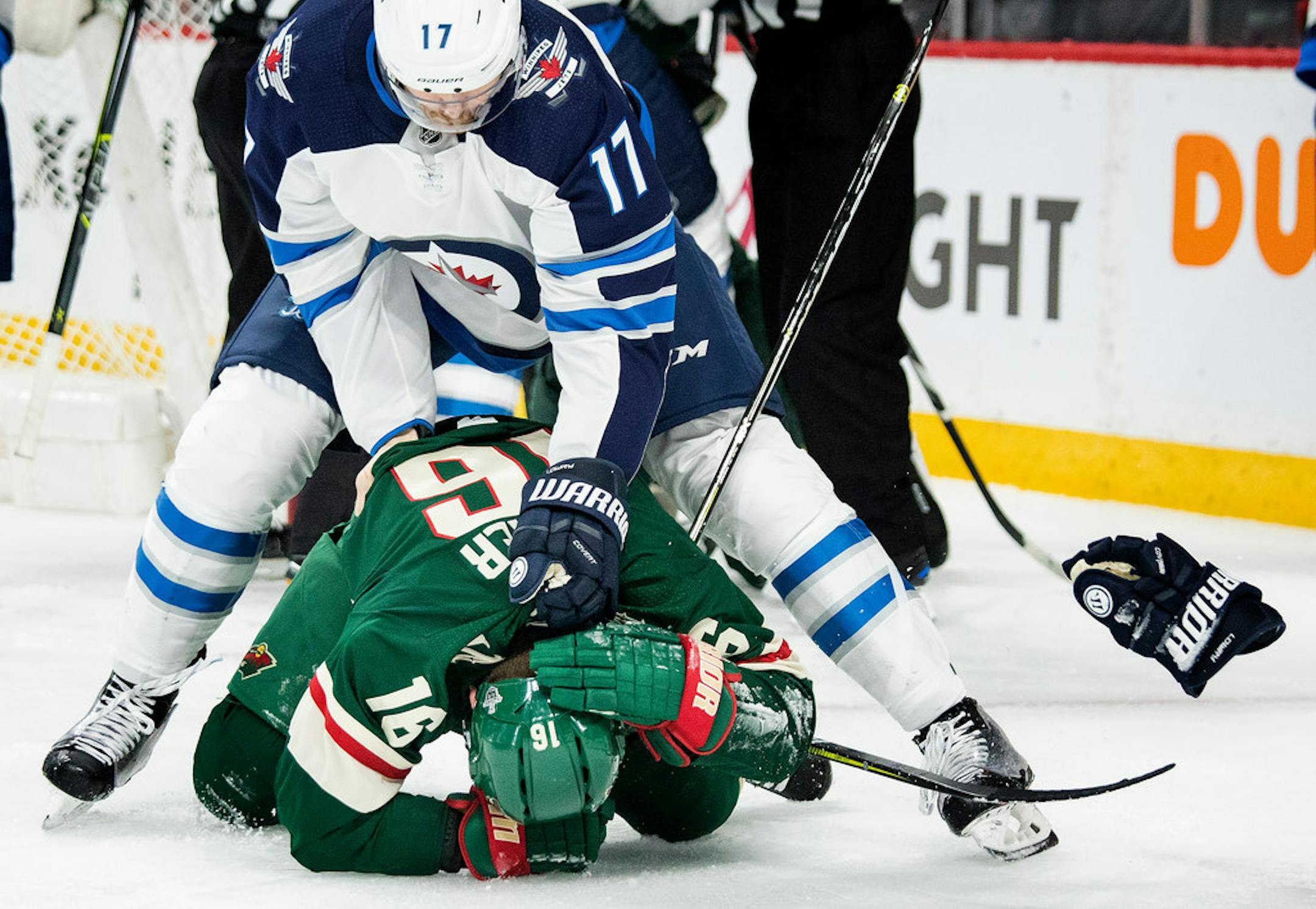 Adam Lowry (17) and Jason Zucker (16) tussled in the first period.