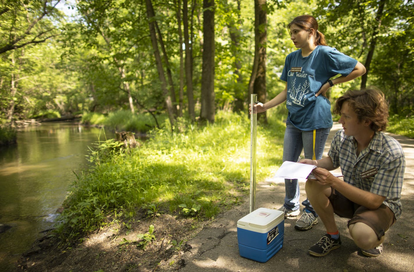 Will Bjorndal, a naturalist intern at he Jay C. Hormel Nature Center in Austin, made notes after he and fellow intern Andie Harveaux took a water sample and measured the clarity in Dobbins Creek as part of the ongoing study of e-coli levels in the creek. In Austin, Minn., local residents have quietly taken matters into their own hands. For the last year a team of 50 people, supported by a McKnight Foundation Grant, have been taking weekly measurements in the Cedar River and its surrounding tribu