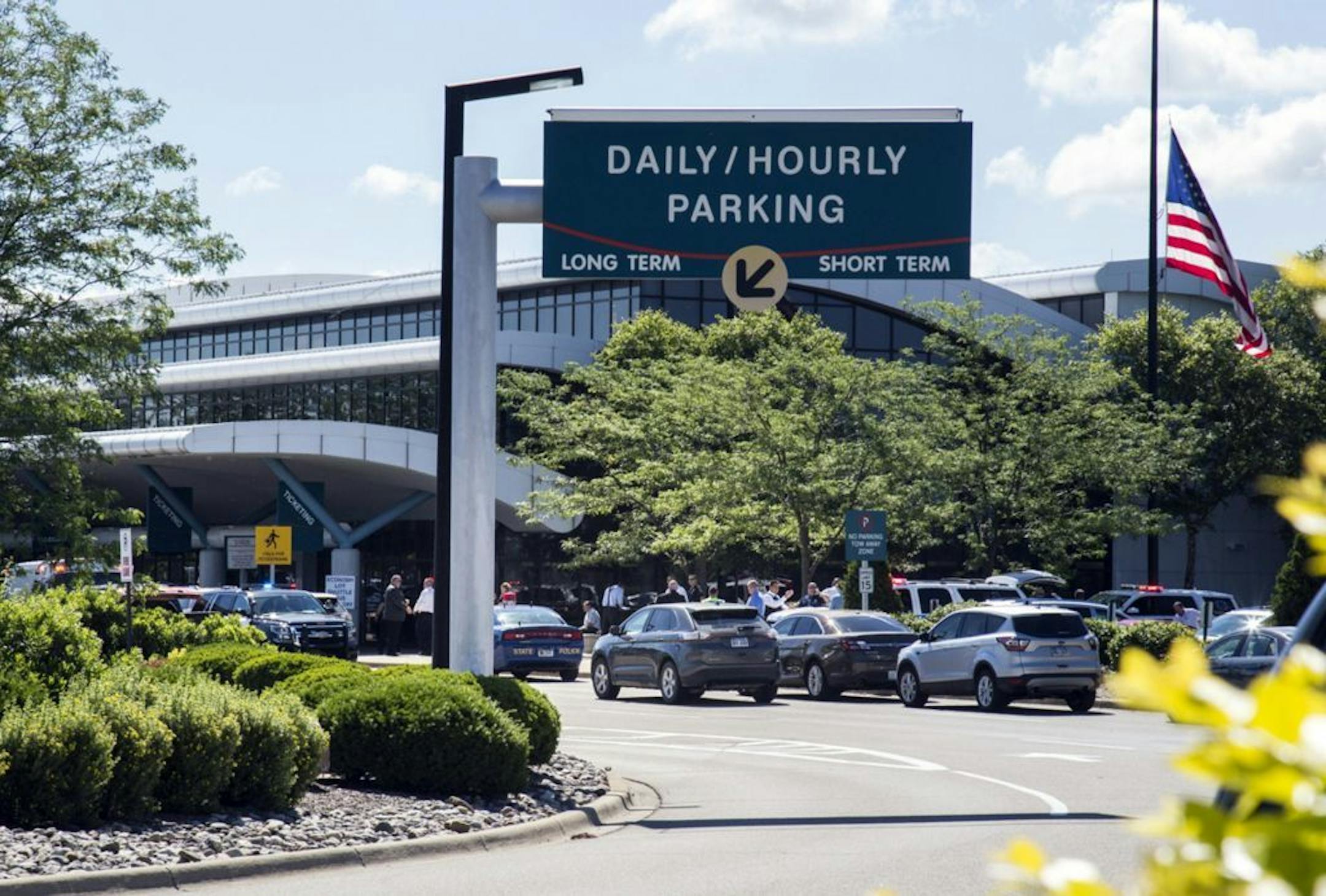 Travellers and traffic sit outside a terminal at Bishop International Airport, Wednesday morning, June 21, 2017, in Flint, Mich. Officials evacuated the airport Wednesday, where a witness said he saw an officer bleeding from his neck and a knife nearby on the ground. On Twitter, Michigan State Police say the officer is in critical condition and the FBI was leading the investigation.
