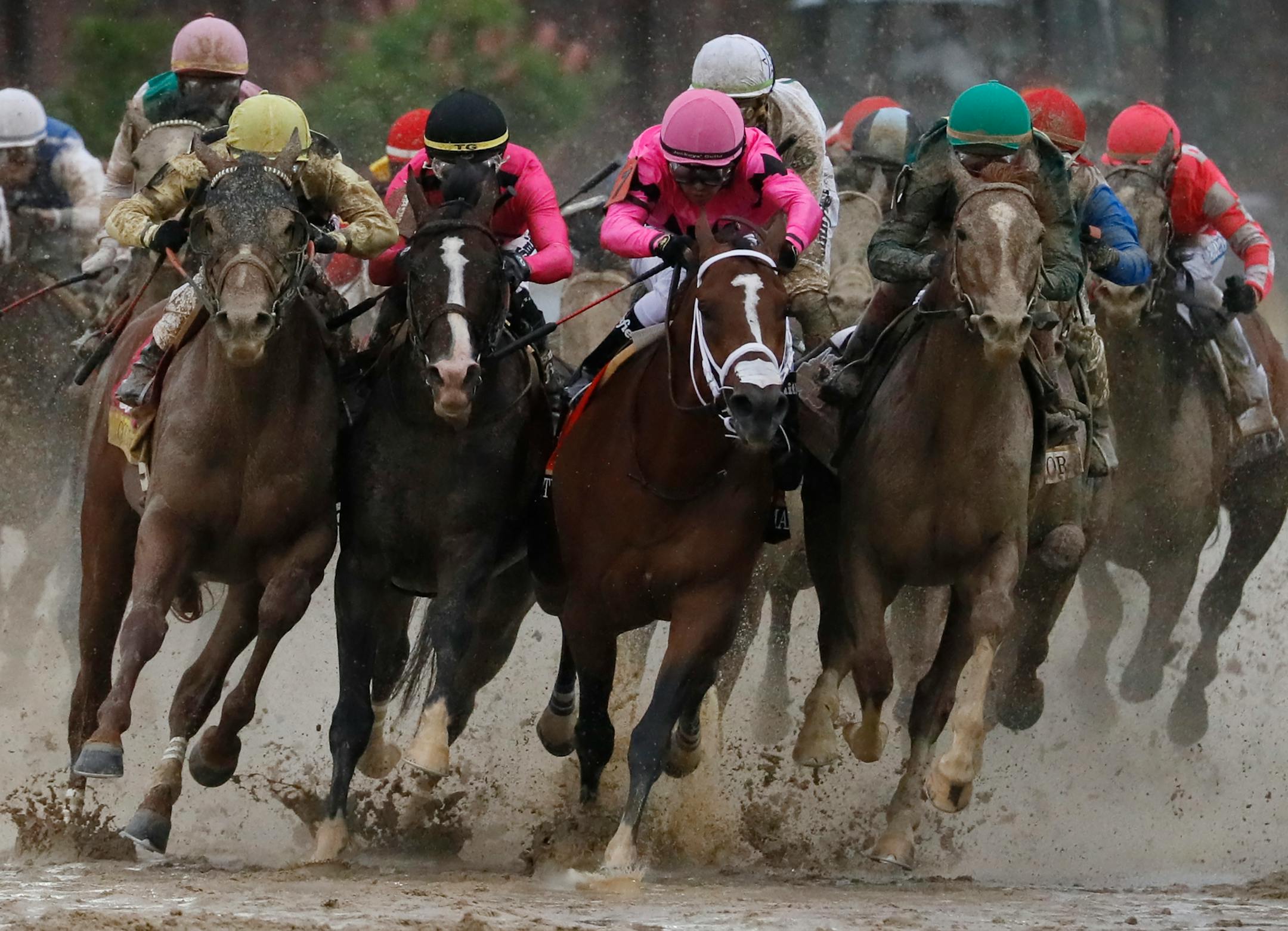Flavien Prat on Country House, left, raced against Luis Saez on Maximum Security, third from left, during the 145th running of the Kentucky Derby on Saturday. Maximum Security was disqualified for interference after the race and Country House was named the winner.