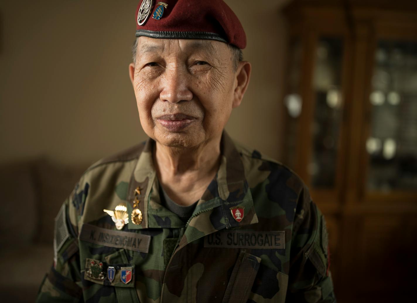 Khao Insixiengmay held a photo of himself when he was 24 years old Wednesday at his home in July 5, 2017 in Brooklyn Park, MN. Col. Insixiengmay is a veteran of the CIA's secret army in Laos during the Vietnam War. He's leading the effort of Lao Army veterans, including thousands of Hmong, to win federal recognition to qualify for burial in national cemeteries.] JERRY HOLT � jerry.holt@startribune.com