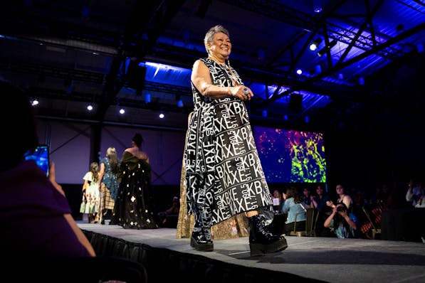 Anishinaabe designer Delina White, who created and produced the event, walks down the runway at the annual Native Nations Fashion Night show at Quincy