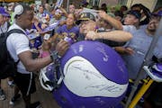 Minnesota Vikings quarterback Teddy Bridgewater signed a large helmet for Milt Toratti, 75, of Cincinnati, Ohio. Veteran players reported for camp on 