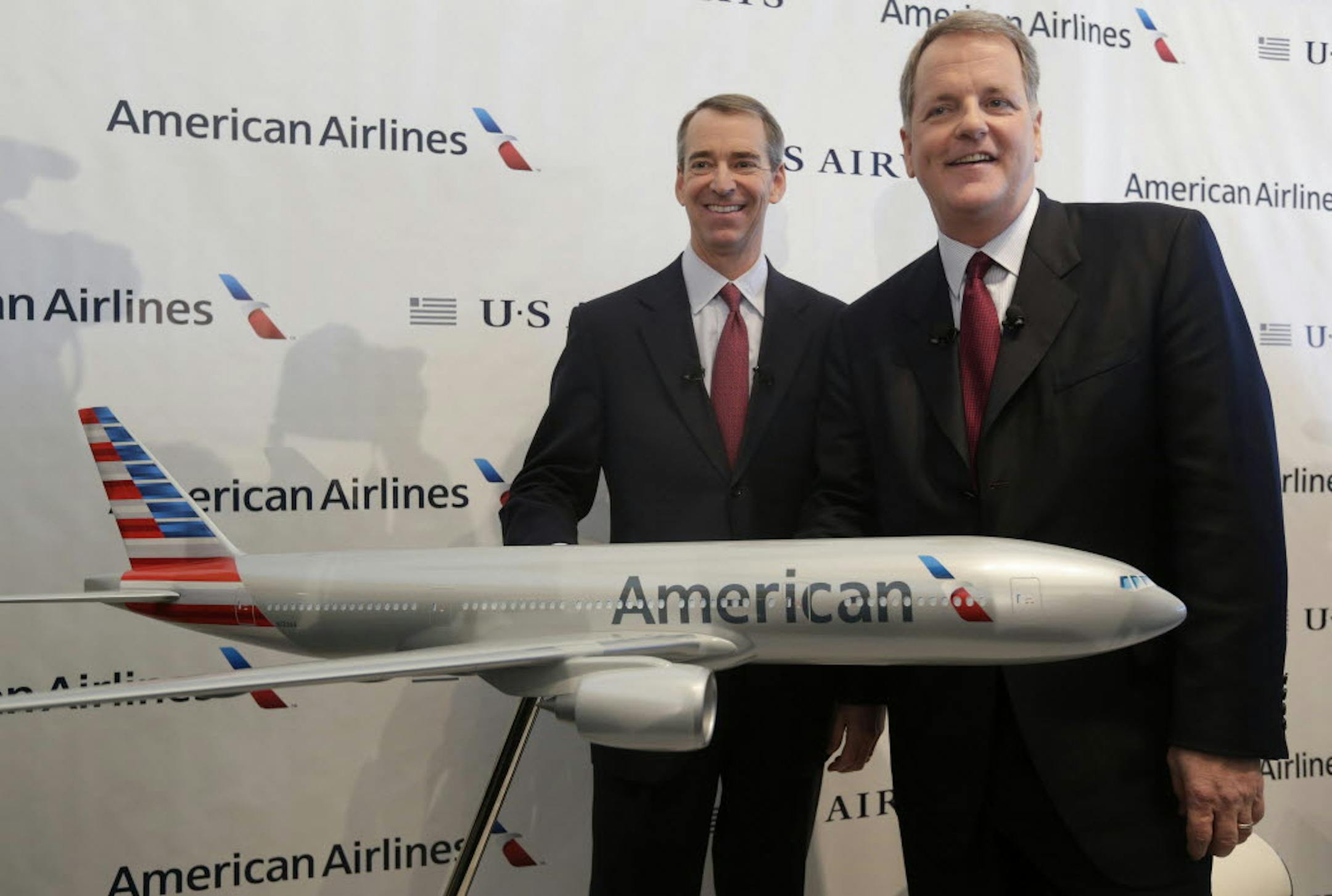 American Airlines CEO Tom Horton, left, and US Airways CEO Doug Parker were all smiles on Thursday.