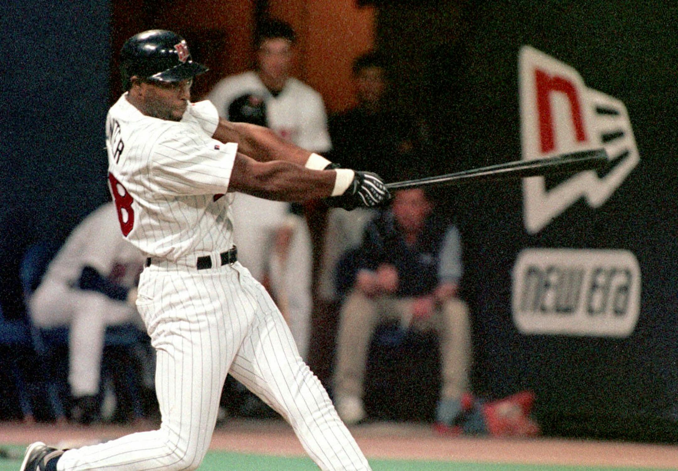Minnesota Twins outfielder Torii Hunter drives the ball into left-center field for a grand slam home run during the fourth inning off Boston Red Sox pitcher Tim Wakefield, Monday, April 26, 1999, in Minneapolis. On base and scoring on the play were teammates Ron Coomer, Chad Allen, and Matt Lawton. Hunter went two for three with five RBIs for the night. The Twins beat the Red Sox 6-2.(AP Photo/Paul Battaglia) ORG XMIT: MIN2015021116422252