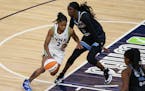 Crystal Dangerfield drives against Chicago Sky's Kahleah Copper during a game in June.