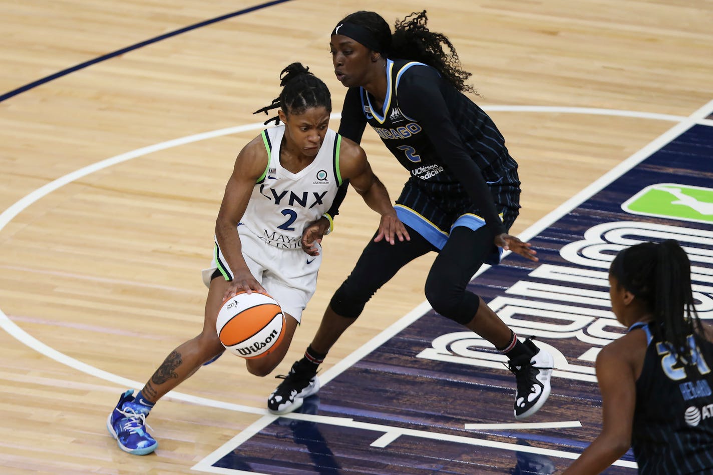 Crystal Dangerfield drives against Chicago Sky's Kahleah Copper during a game in June.