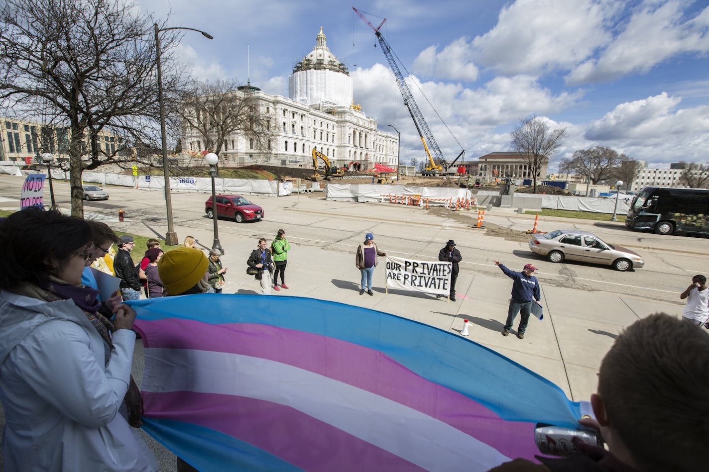 People listen to speakers during a Transgender Day of Visibility rally at the Capitol in St. Paul.