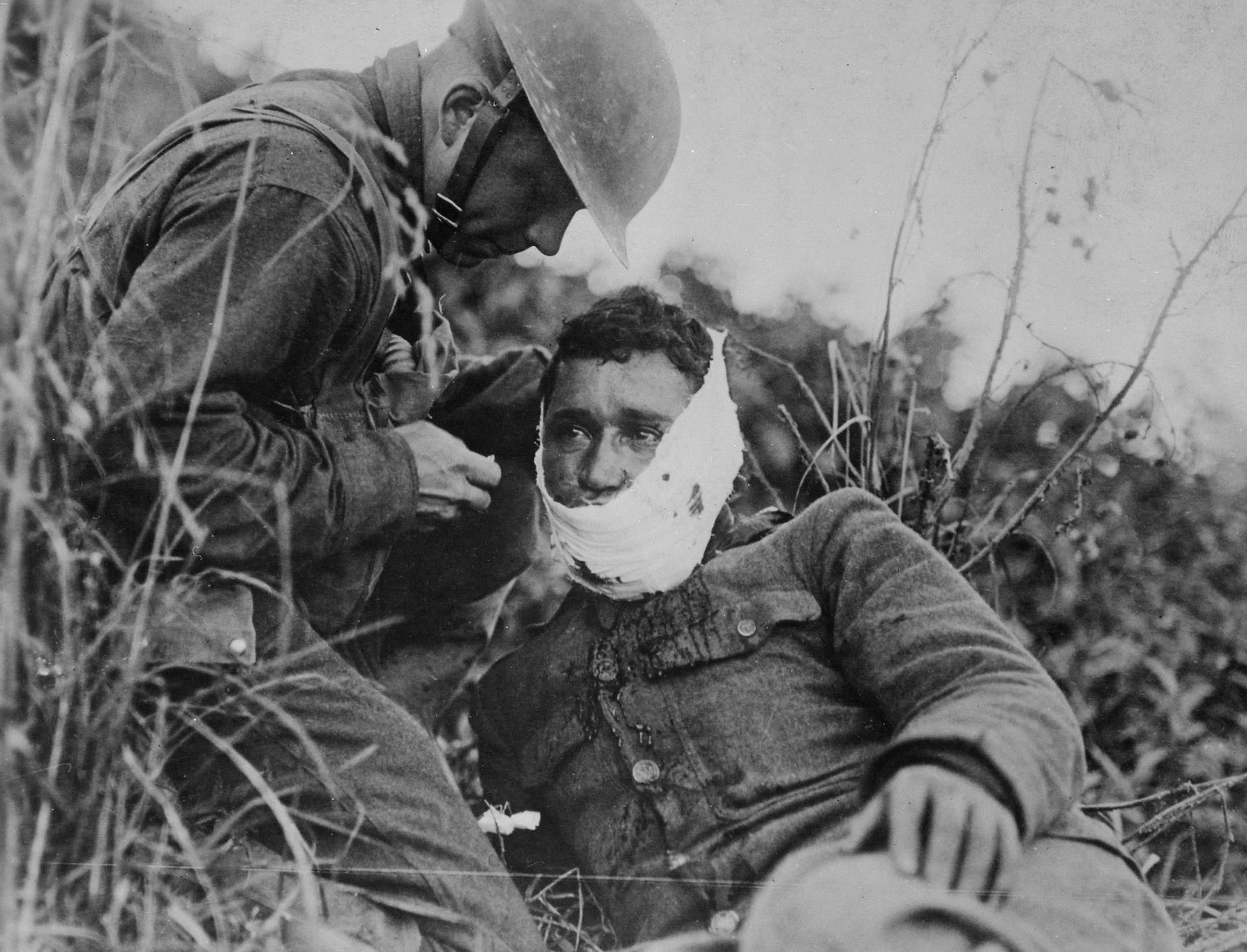 Credit: Courtesy of National Archives
Photo Caption
An American soldier wraps another soldierís head wound at Varennes-en-Argonne, France (September 1918)