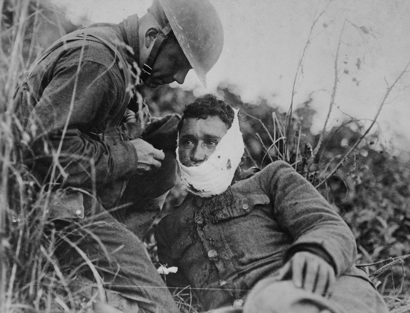 Credit: Courtesy of National Archives
Photo Caption
An American soldier wraps another soldier&#xed;s head wound at Varennes-en-Argonne, France (September 1918)