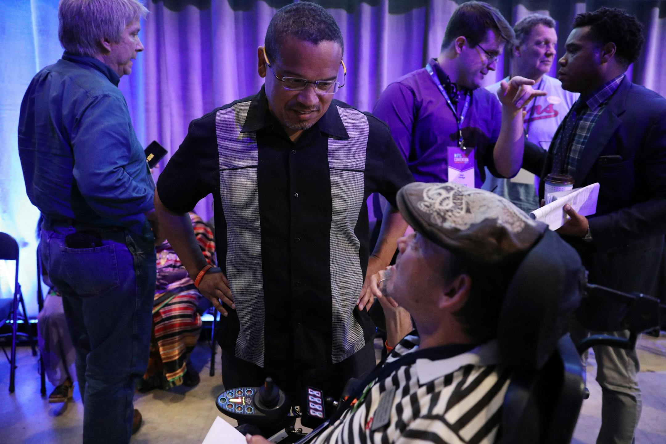 U.S. Rep. Keith Ellison, D-Minnesota, spoke with delegate James Berry after speaking during the DFL State Convention Friday.