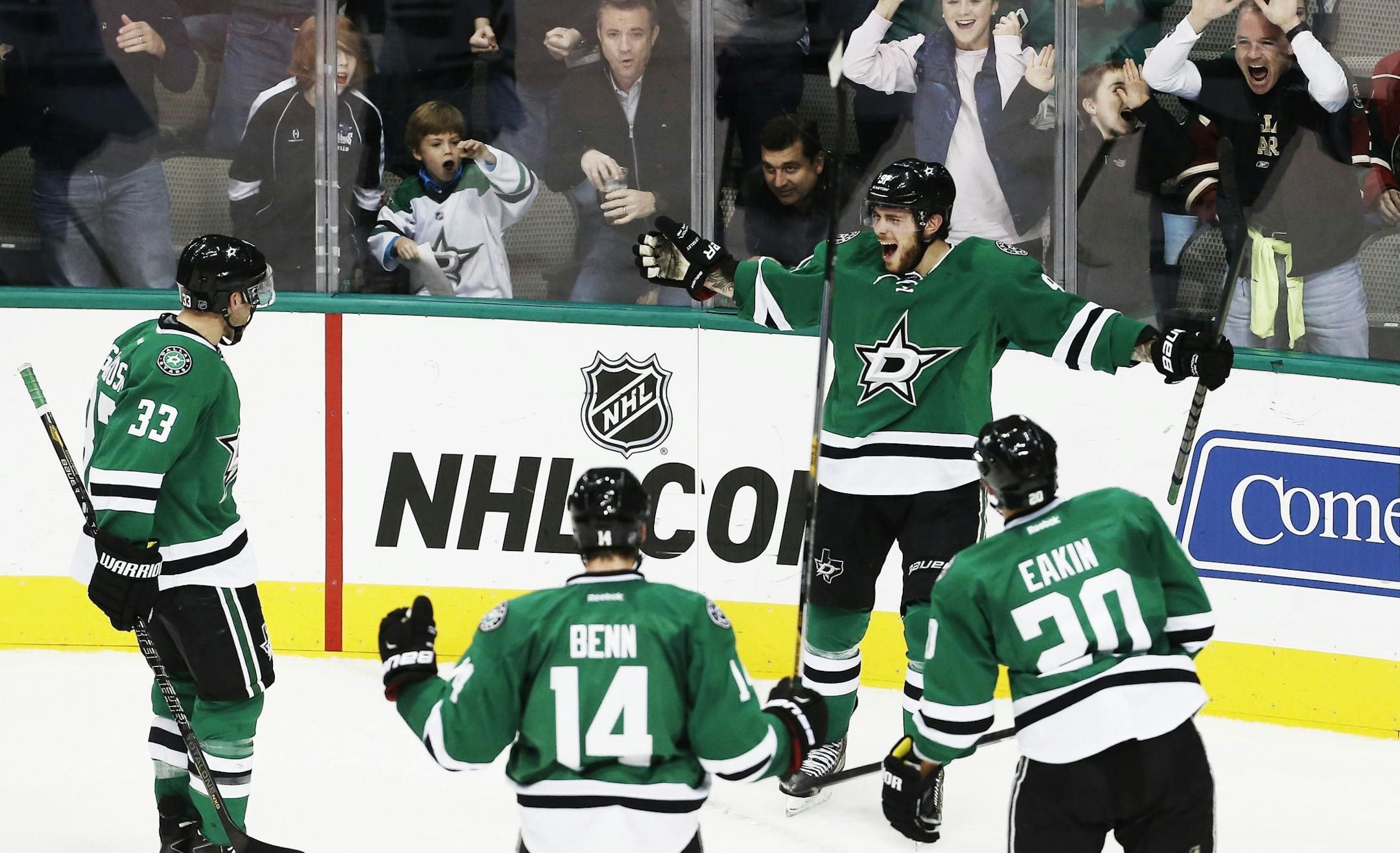 Dallas Stars forward Tyler Seguin (91) is congratulated by defenseman Alex Goligoski (33), and forwards Jamie Benn (14) and Cody Eakin (20) in the first period of an NHL hockey game against the Minnesota Wild, Friday, Nov. 28, 2014, in Dallas.