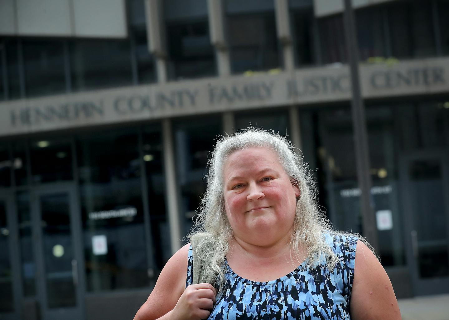 Tracy Schutt, a Hennepin County principal child support officer, stood outside her work place at the Hennepin County Family Justice Center Tuesday, July 2, 2019, in Minneapolis, MN. In fighting the dismissal, Schutt spent $40,000 in legal costs. "I love my job," Schutt said. "I'm so passionate about it."] DAVID JOLES • david.joles@startribune.com Tracy Schutt, a Hennepin County principal should support officer, was fired in 2018 by Hennepin County and got her job back eight months later through