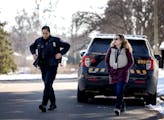 Ramsey County social worker Amy Kuusisto-Lathrop and Maplewood police officer Emily Burt-McGregor walked from a squad car on Nov. 21.