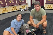 Gophers women's hockey standout Abbey Murphy posed with her older brother Dominic, a St. Cloud State wrestler, and his dog, Messi, in the Gophers lock