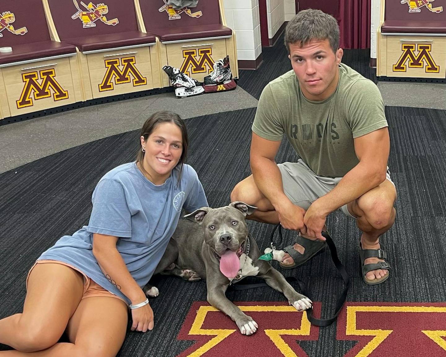 Gophers women's hockey standout Abbey Murphy posed with her older brother Dominic, a St. Cloud State wrestler, and his dog, Messi, in the Gophers locker room at Ridder Arena recently. (undated, but January 2024, presumably) (provided photo)