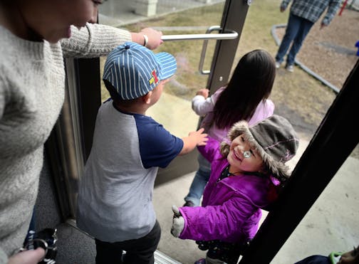 At the Jeremiah Program in St. Paul, Sinying Lee picked up her youngest child Cattleya,3. The older kids Benjamin,4, and Pashalia,5, came along for the pickup. ]