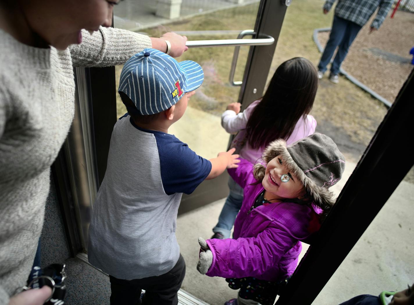 At the Jeremiah Program in St. Paul, Sinying Lee picked up her youngest child Cattleya,3. The older kids Benjamin,4, and Pashalia,5, came along for the pickup. ]