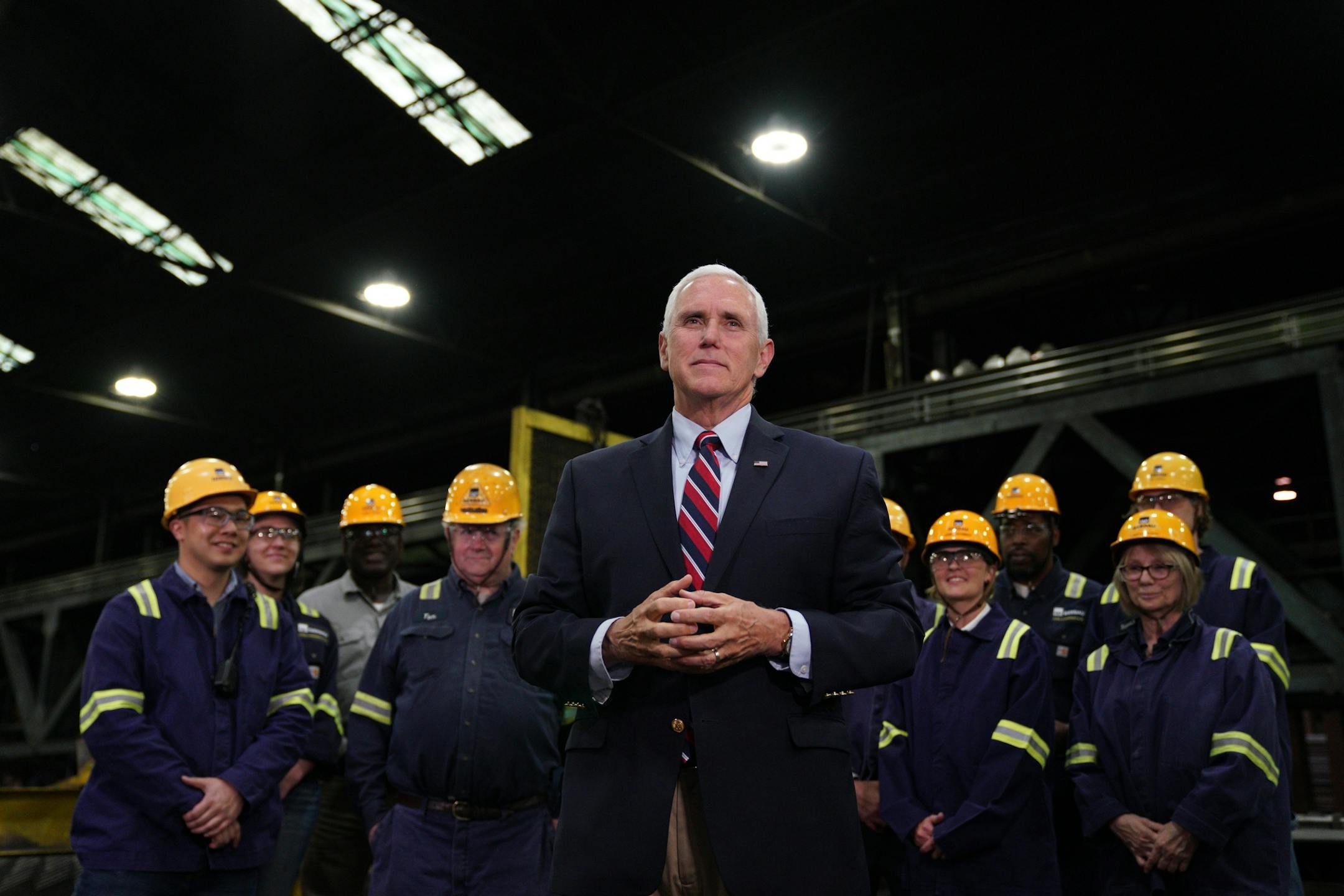 Vice President Mike Pence answered questions from reporters as he stood with a select group of steel workers after giving a speech urging support for President Donald Trump's proposed replacement for the North American Free Trade Agreement at Gerdau Ameristeel Thursday.