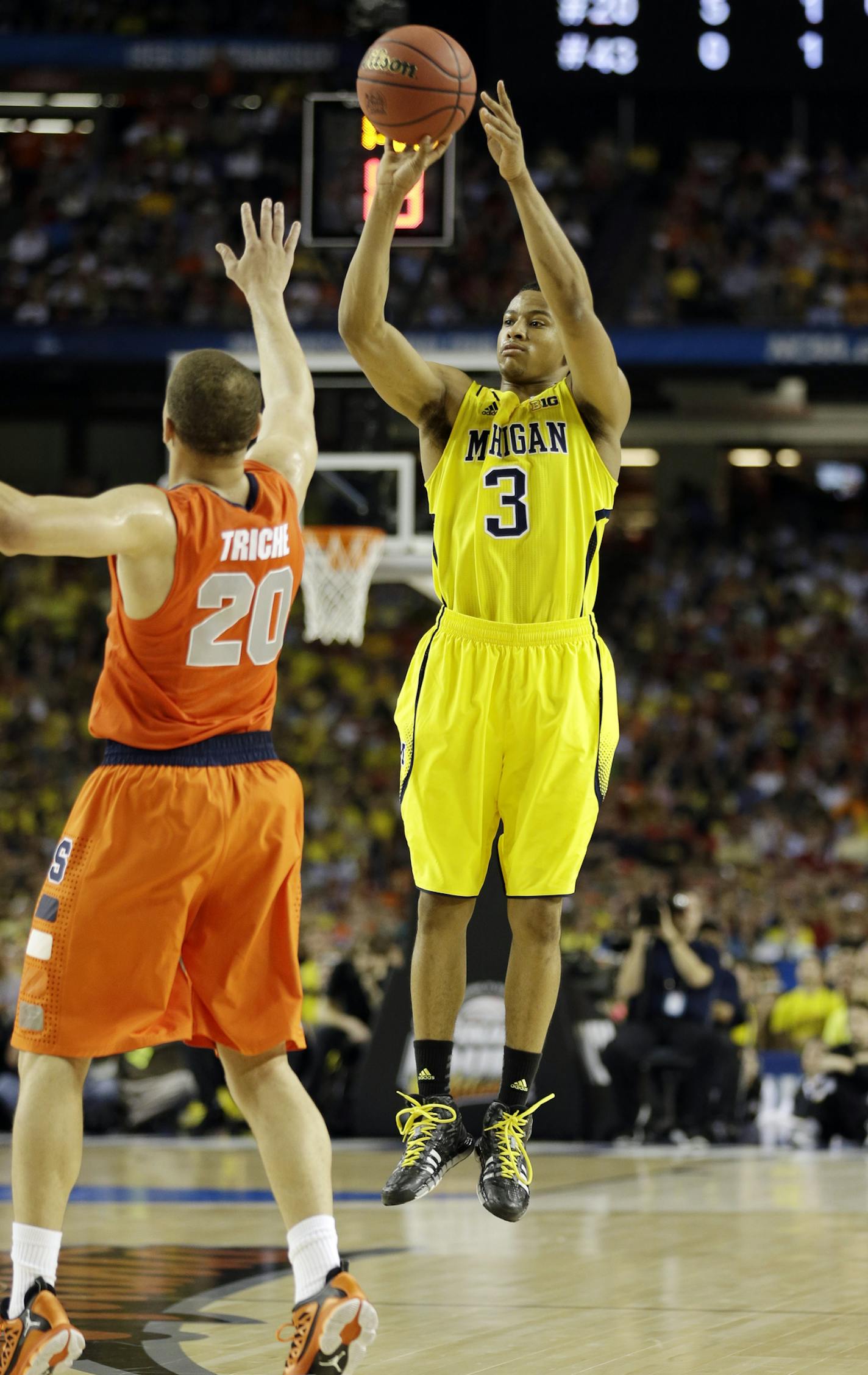 Michigan's Trey Burke (3) shoots against Syracuse's Brandon Triche (20) during the first half of the NCAA Final Four tournament college basketball semifinal game Saturday, April 6, 2013, in Atlanta. (AP Photo/John Bazemore)