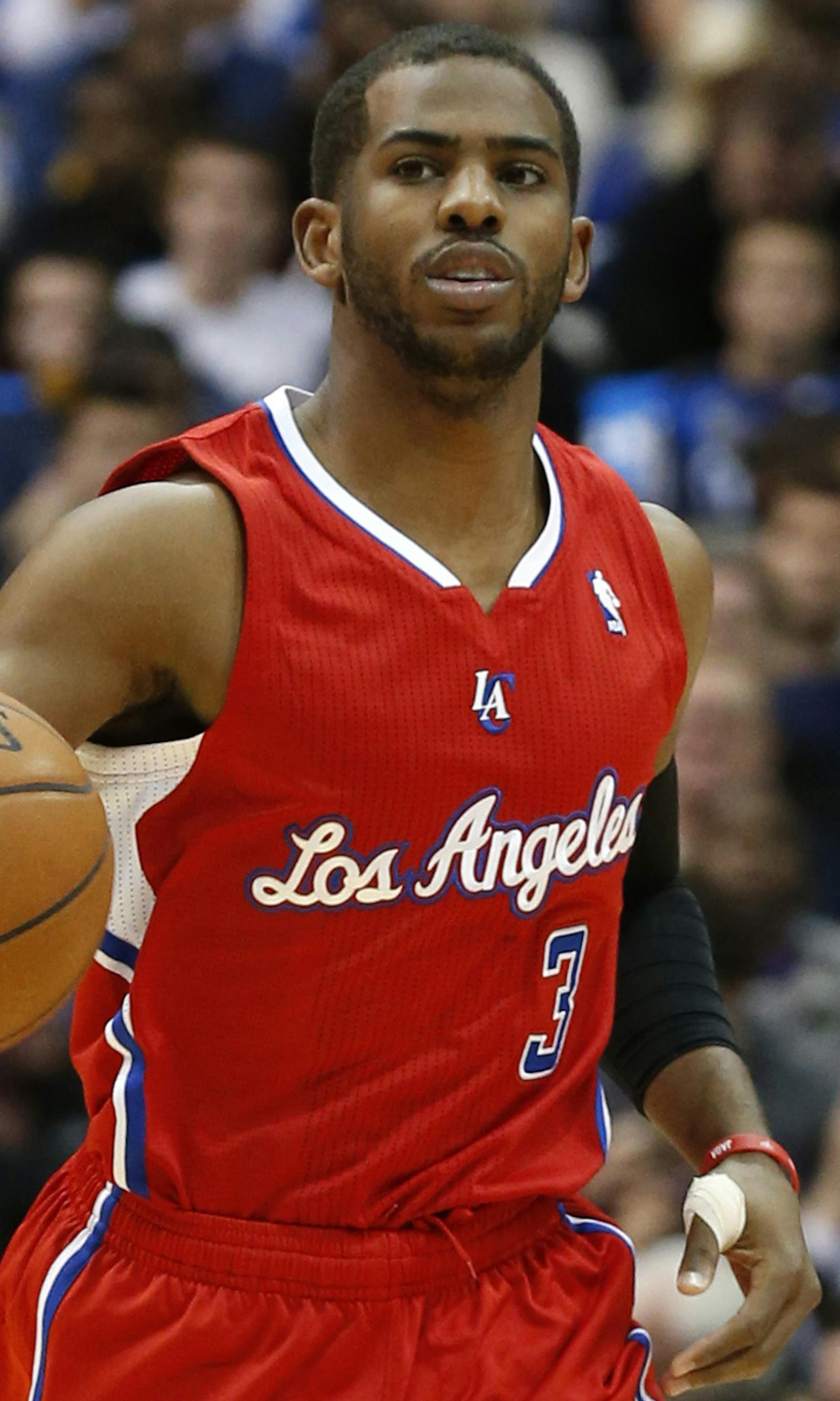 Los Angeles Clippers guard Chris Paul (3) controls the ball during the first half of an NBA basketball game against the Dallas Mavericks Friday, Jan. 3, 2014, in Dallas. The Clippers won 119-112. (AP Photo/Sharon Ellman)