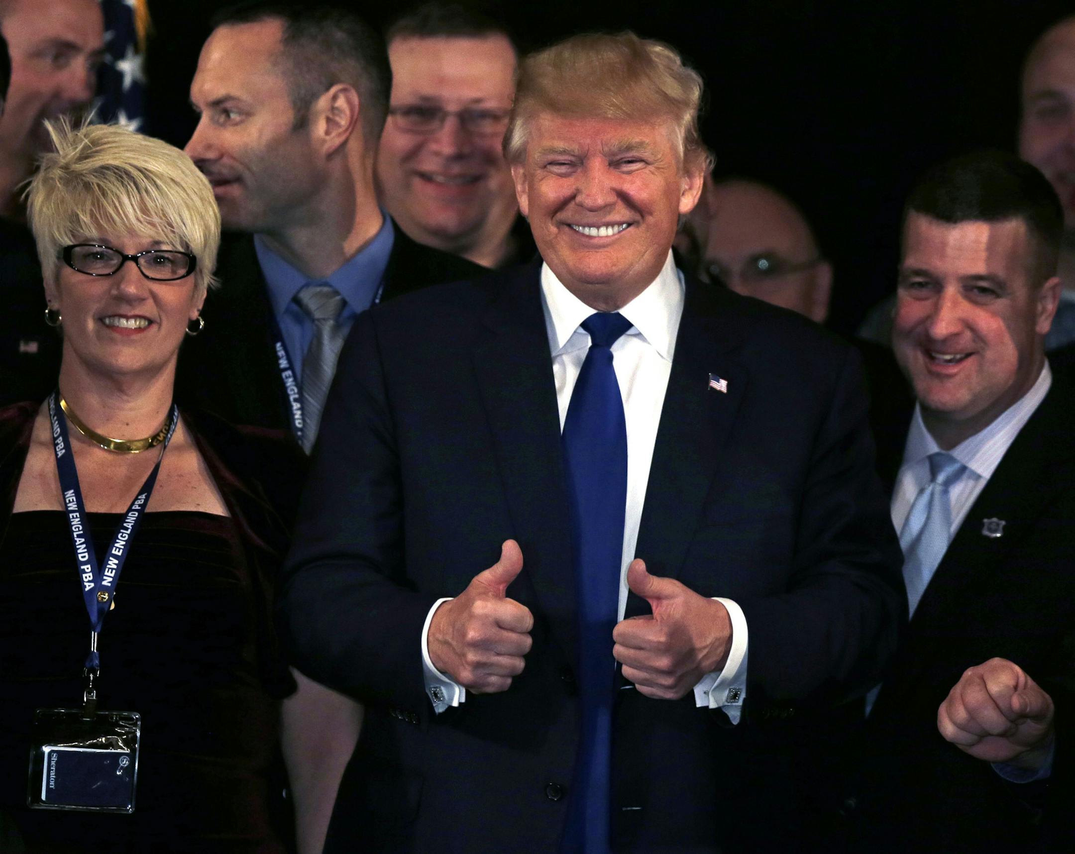 Republican presidential candidate, Donald Trump flashes thumbs up after being endorsed at a regional police union meeting in Portsmouth, N.H., Thursday, Dec. 10, 2015. (AP Photo/Charles Krupa)