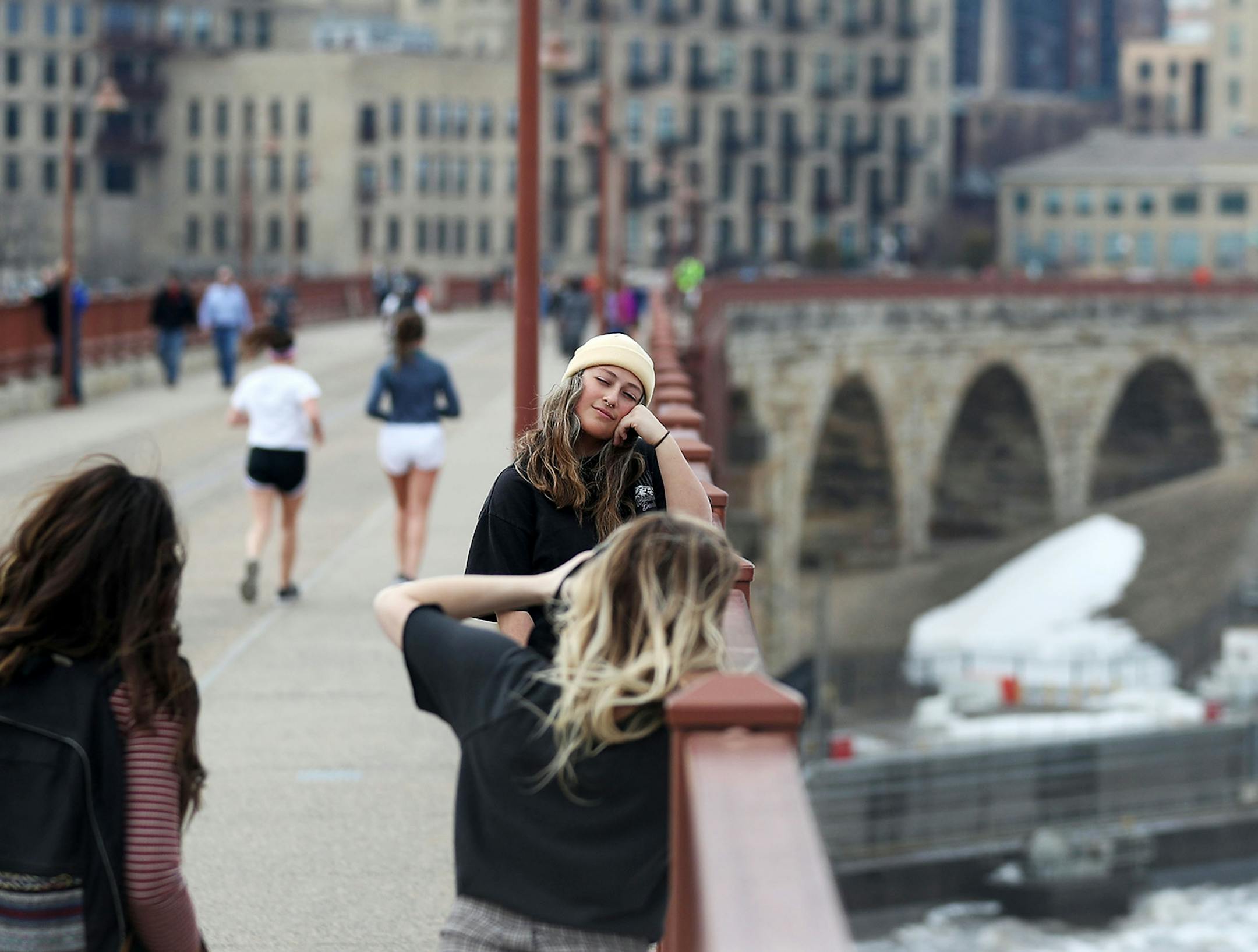 It was a short sleeve, even shorts day for some as temps reached into the 60s. Here, Hannah Garcia is photographed by Emily Johnson, while Annalise Garcia, left, looks on Wednesday, March 27, 2019, at the Stone Arch Bridge in Minneapolis, MN. The women are all students at North Central University and were taking a picture break while long boarding.
