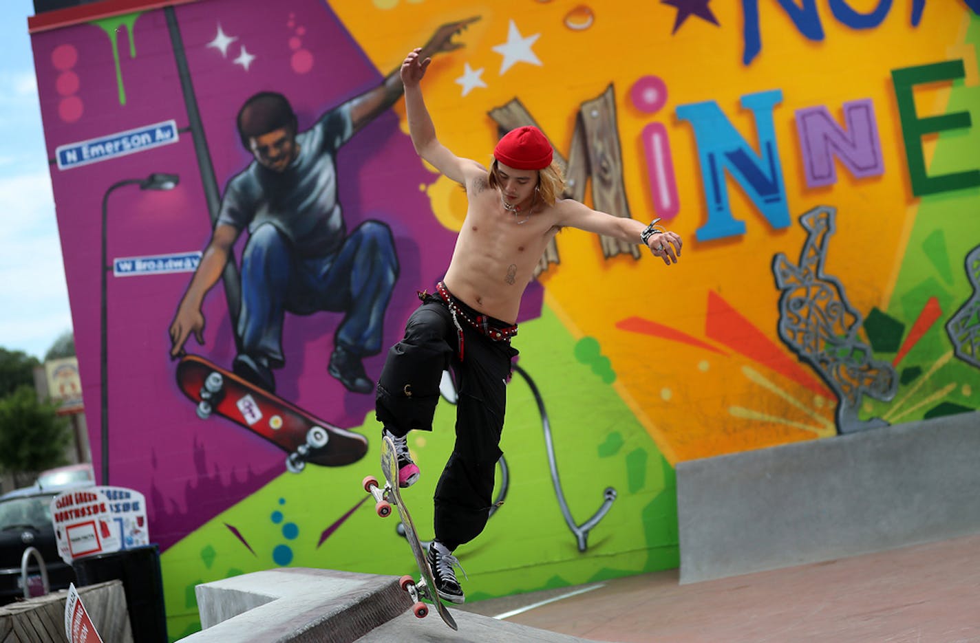 Blake Vang, 21, of Lake Elmo, tried out a quarter-pipe at the new skate-able art park in north Minneapolis, his moves echoed by a mural by New York's Tats Cru.