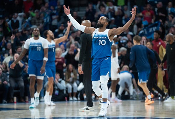 Wolves guard Mike Conley celebrates after the Cavaliers call timeout in the fourth quarter Friday night at Target Center.