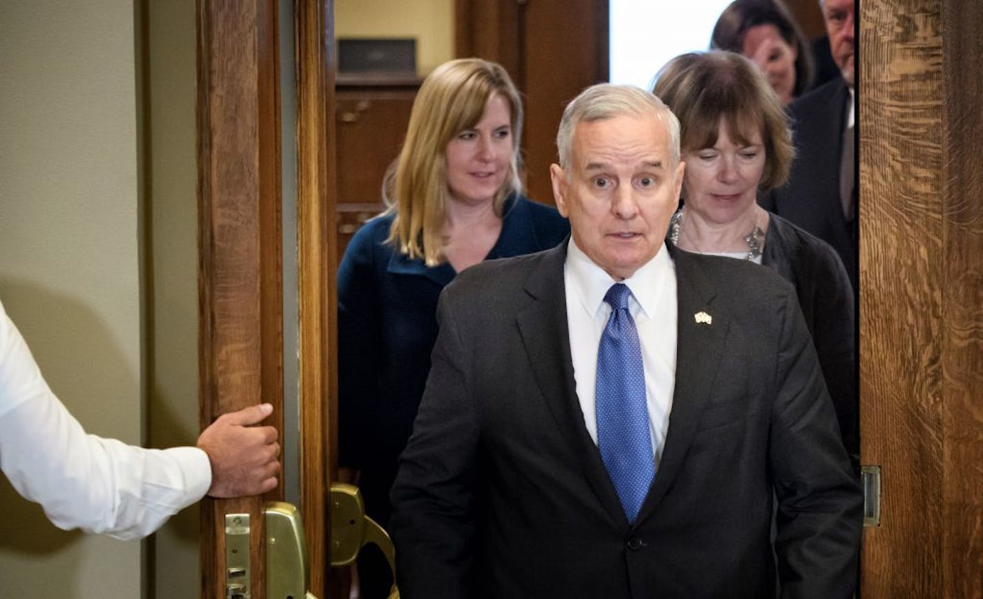 Gov. Mark Dayton emerges from a meeting room Wednesday at the Capitol after meeting with Republican leaders on the budget.