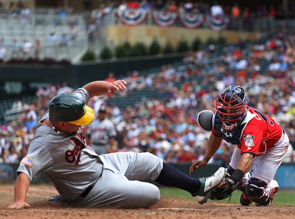 Billy Butler(16) scored at home before catcher Juan Centeno(37) could apply the tag in the seventh inning making the score 3-1.[At the Twins game agai