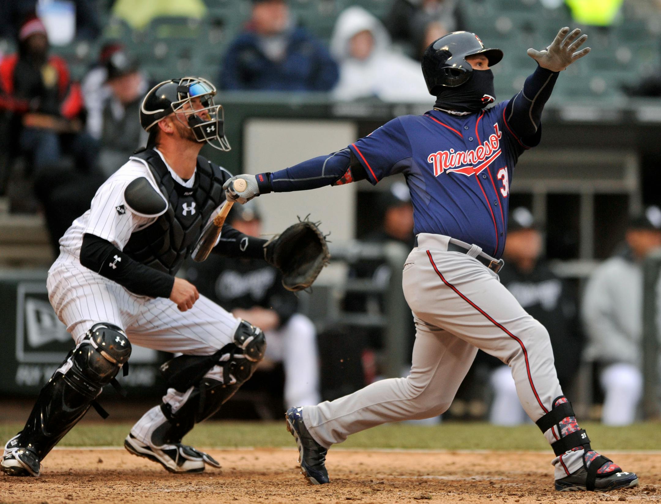 Minnesota Twins' Oswaldo Arcia (31), follows through on an RBI triple during the ninth inning of a baseball game against the Chicago White Sox in Chicago, Thursday, April 3, 2014. Minnesota won 10-9. (AP Photo/Paul Beaty)