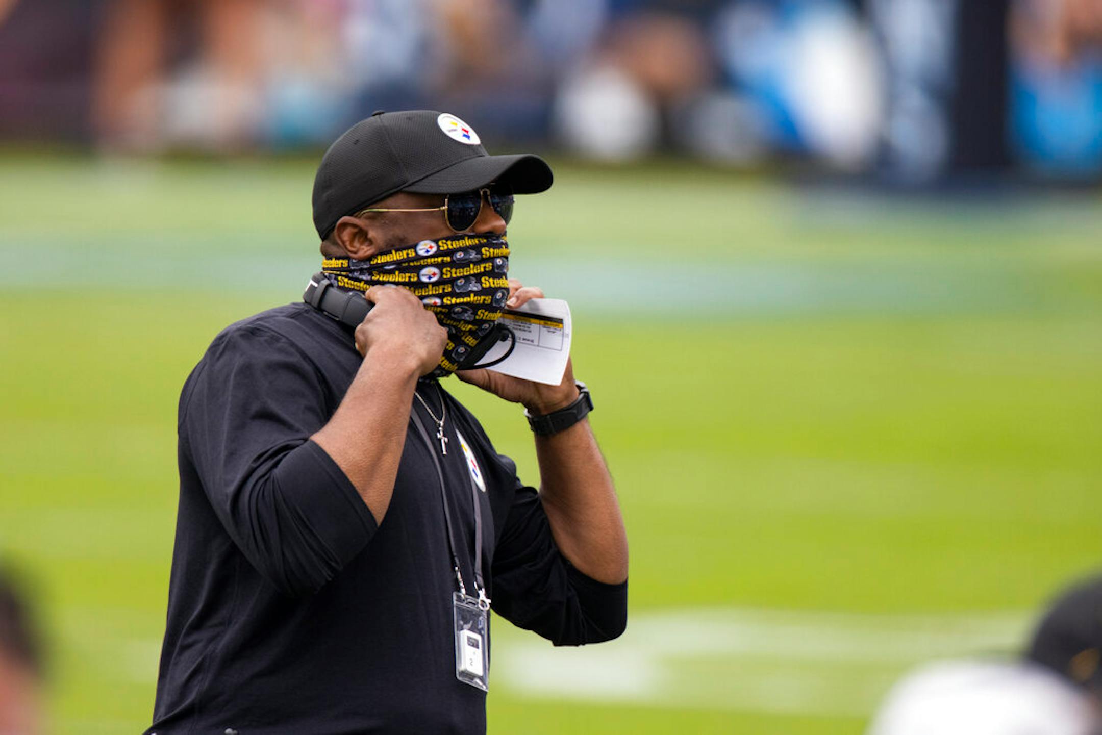 Pittsburgh Steelers head coach Mike Tomlin puts on his headset before an NFL football game against the Tennessee Titans, Sunday, Oct. 25, 2020, in Nashville, Tenn. (AP Photo/Brett Carlsen)