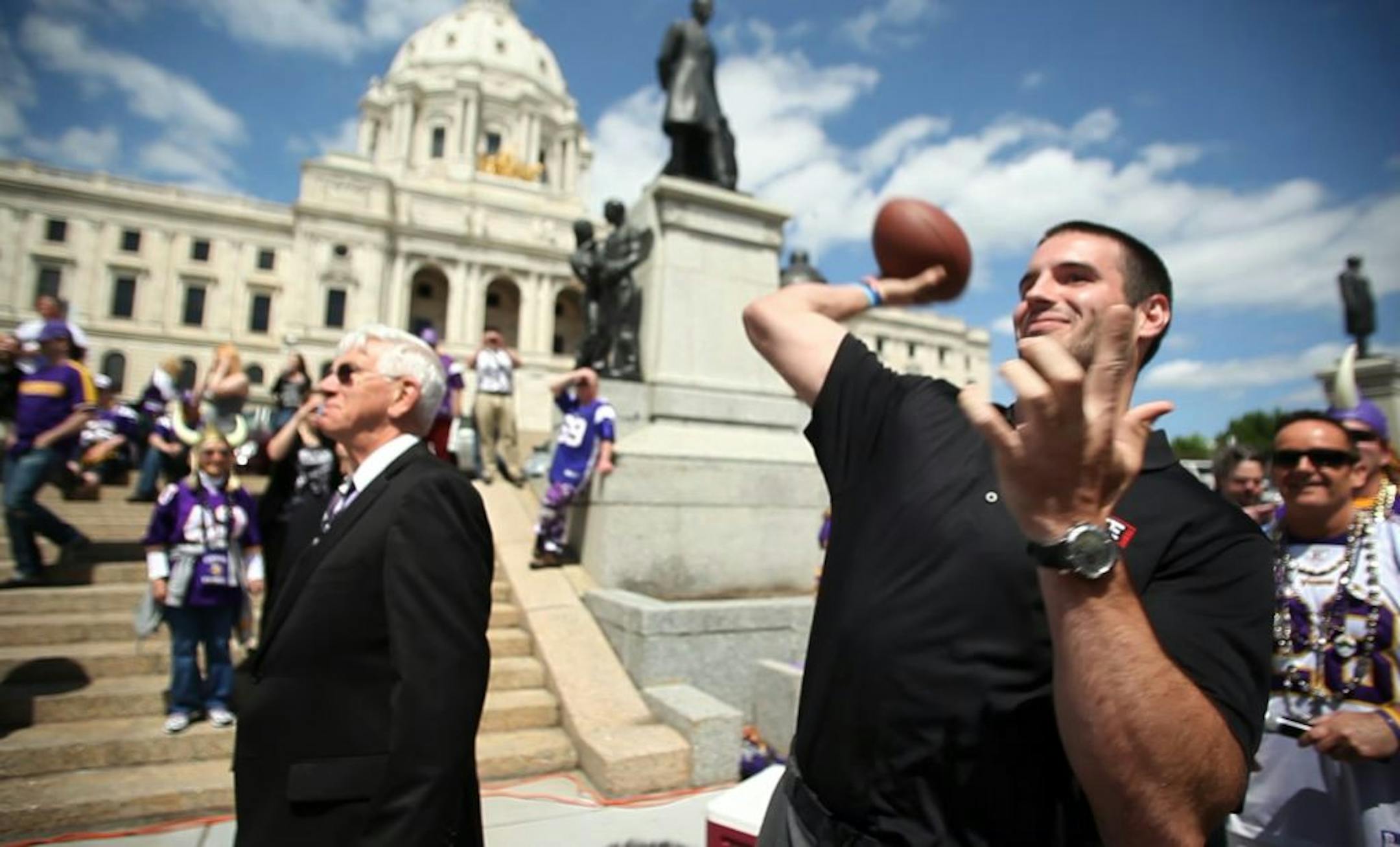 Vikings quarterback Christian Ponder threw a pass to super-fan Larry Spooner on Monday outside the State Capitol during the Vikings stadium debate in the House chamber. (MCKENNA EWEN/STAR TRIBUNE) mckenna.ewen@startribune.com