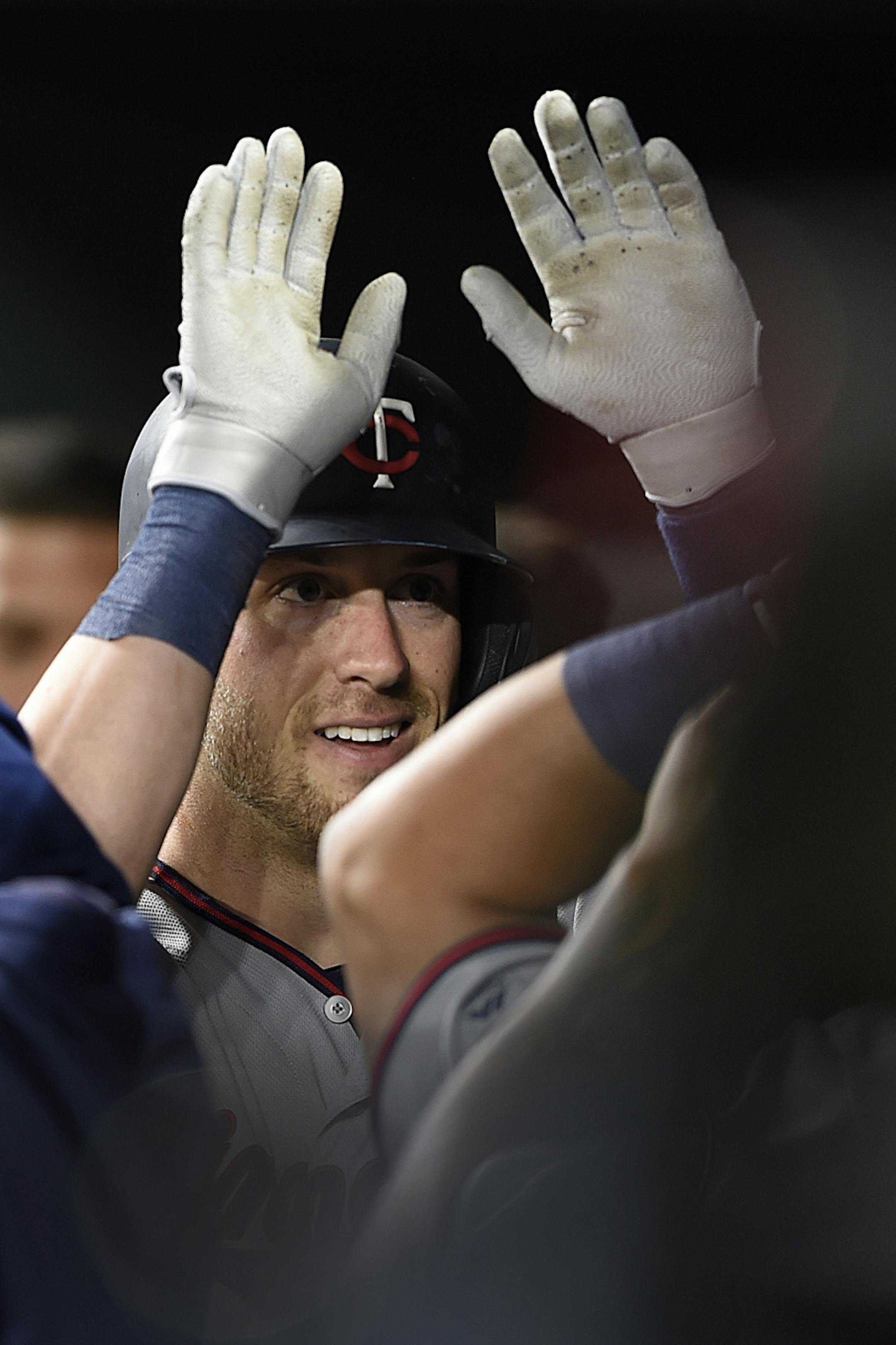 Minnesota Twins Mitch Garver is congratulated after hitting a solo home run against the Baltimore Orioles in the eighth inning of the second game of a baseball doubleheader, Saturday, April 20, 2019, in Baltimore.