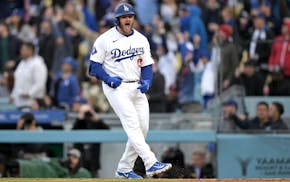 Dodgers star Max Muncy celebrates after hitting a two-run homer in the eighth inning against the Cardinals on Sunday in Los Angeles.