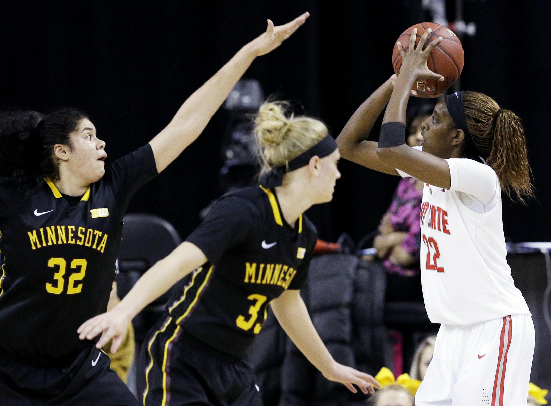 Ohio forward Alexa Hart, right, shoots against Minnesota center Amanda Zahui, left, and guard Carlie Wagner during the first half of an NCAA college basketball game in the quarterfinals of the Big Ten Conference tournament in Hoffman Estates, Ill., on Friday, March 6, 2015. (AP Photo/Nam Y. Huh)