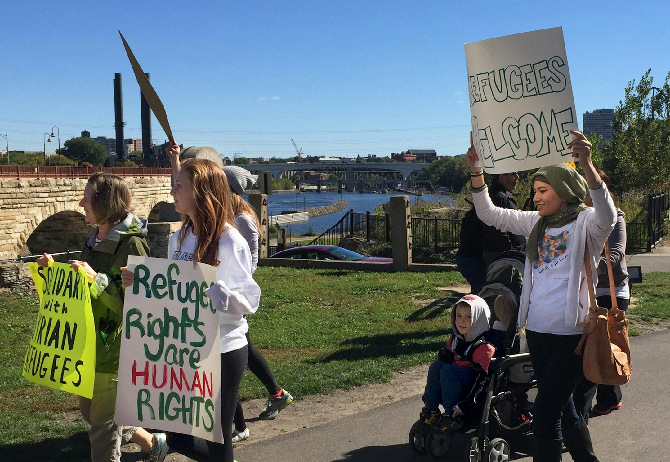Suzan Boulad, far right, is University of Minnesota law student and a Syrian-American who helped organize the demonstration at Gold Medal Park on Saturday, Oct. 3, 2015, and led a rally last month at Minnehaha Park.