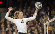 Minnesota middle blocker Molly Lohman (13) spiked the ball for a point against Jackson State.
