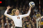 Minnesota middle blocker Molly Lohman (13) spiked the ball for a point against Jackson State.