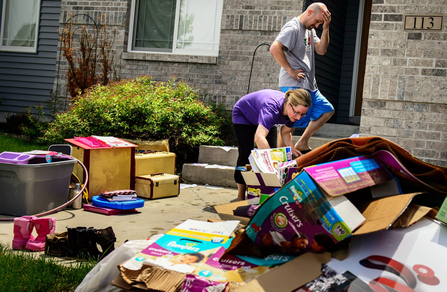 Melany and Chase Sutton cleared out the contents of a flooded basement caused by overnight torrential rains around Mankato. Their sump pump failed. ] GLEN STUBBE * gstubbe@startribune.com Wednesday June 18, 2014 EDS, Melany is cq