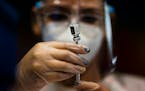 A nurse prepared a dose of the Pfizer COVID-19 vaccine at the Tomas Dones Coliseum, in Fajardo, Puerto Rico, Jan. 8, 2022.