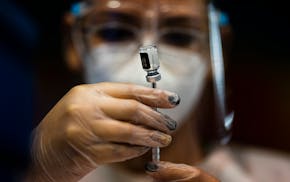 A nurse prepared a dose of the Pfizer COVID-19 vaccine at the Tomas Dones Coliseum, in Fajardo, Puerto Rico, Jan. 8, 2022.